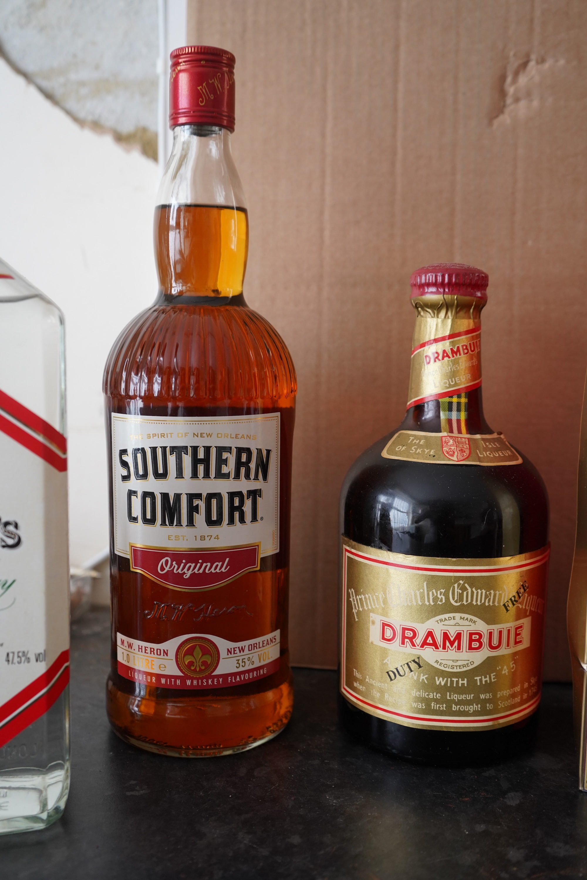 Six bottles of spirits and liqueurs, including whiskey and gin